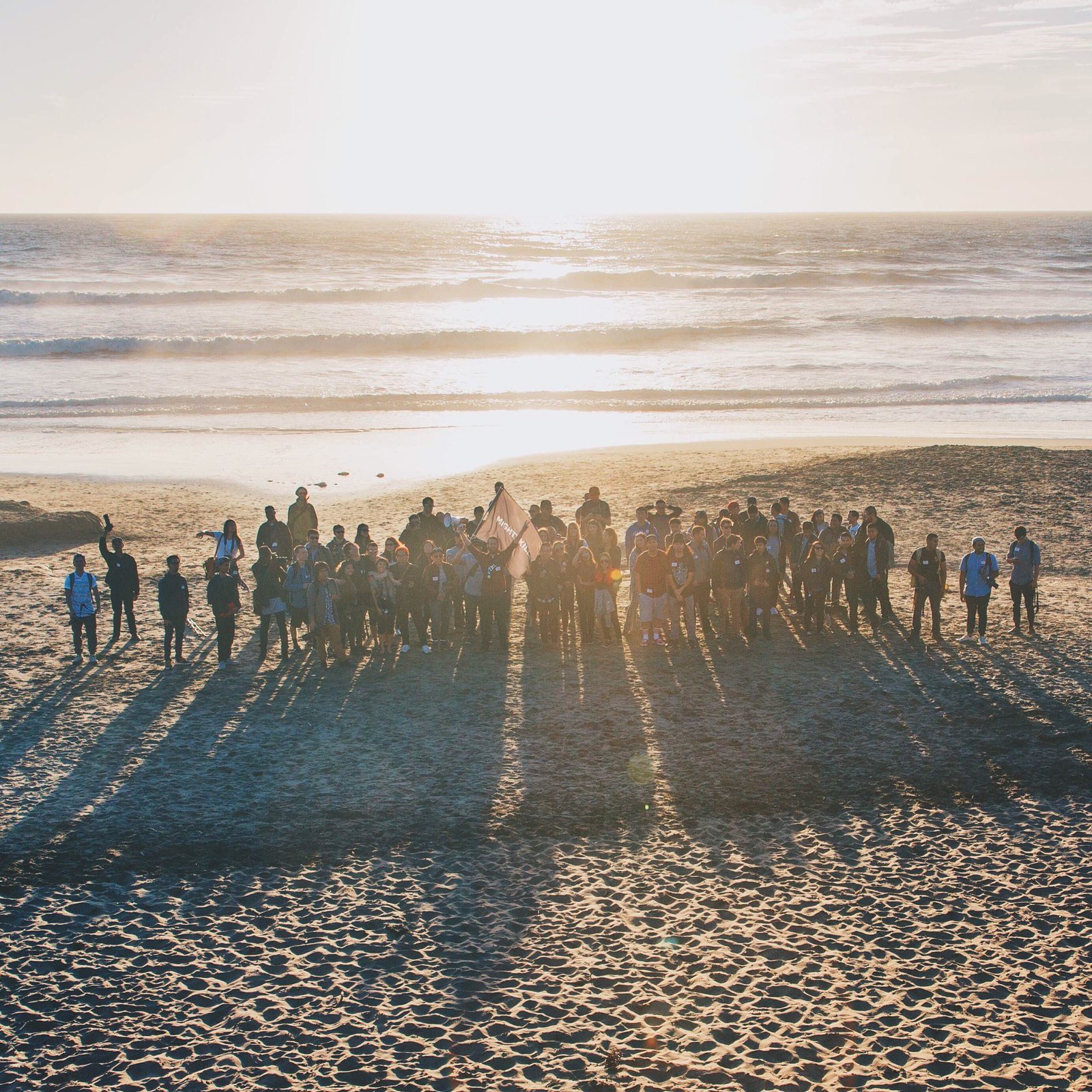 Group photo of creators at a beach meetup