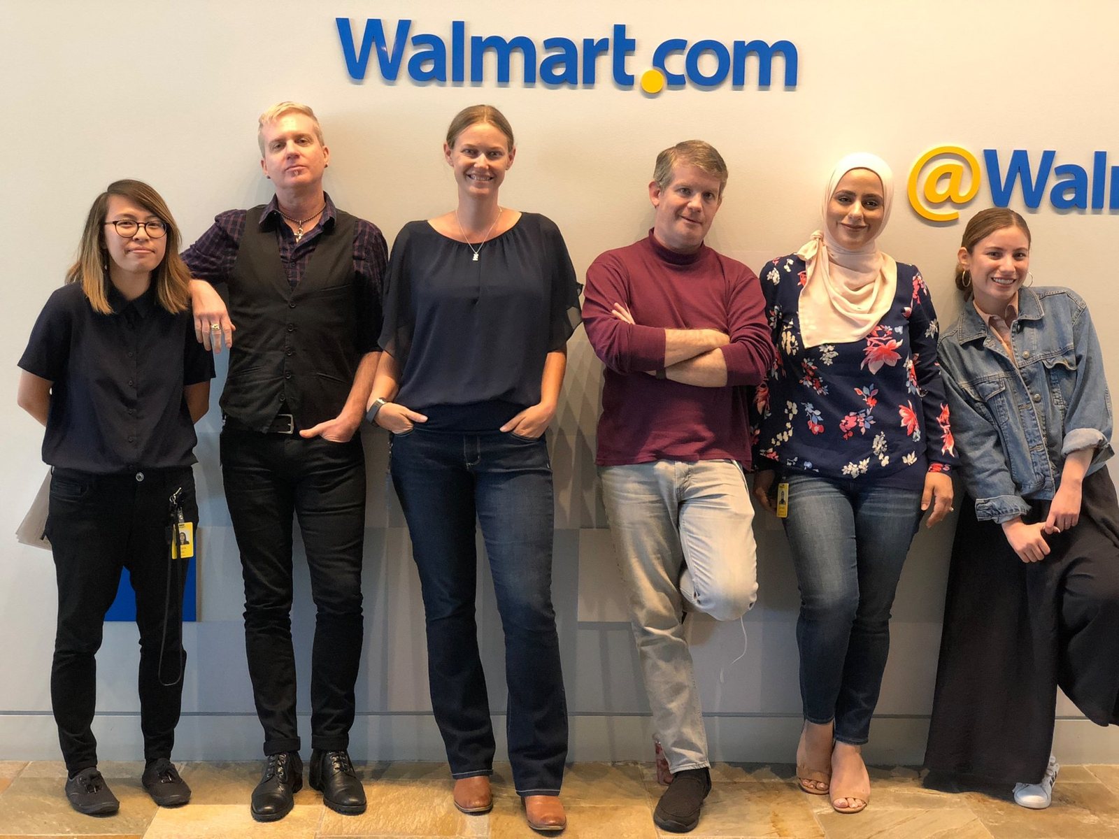 Diana with five teammates in front of the Walmart.com sign