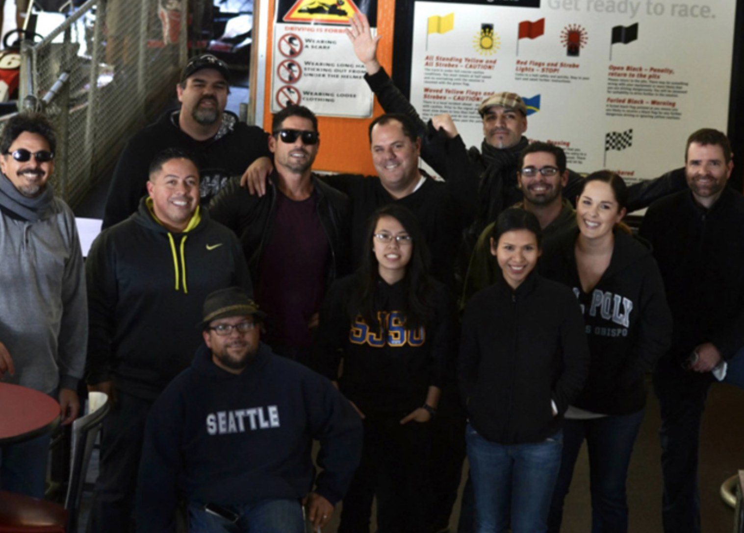 The dystrick design team in a group photo at a go-kart track