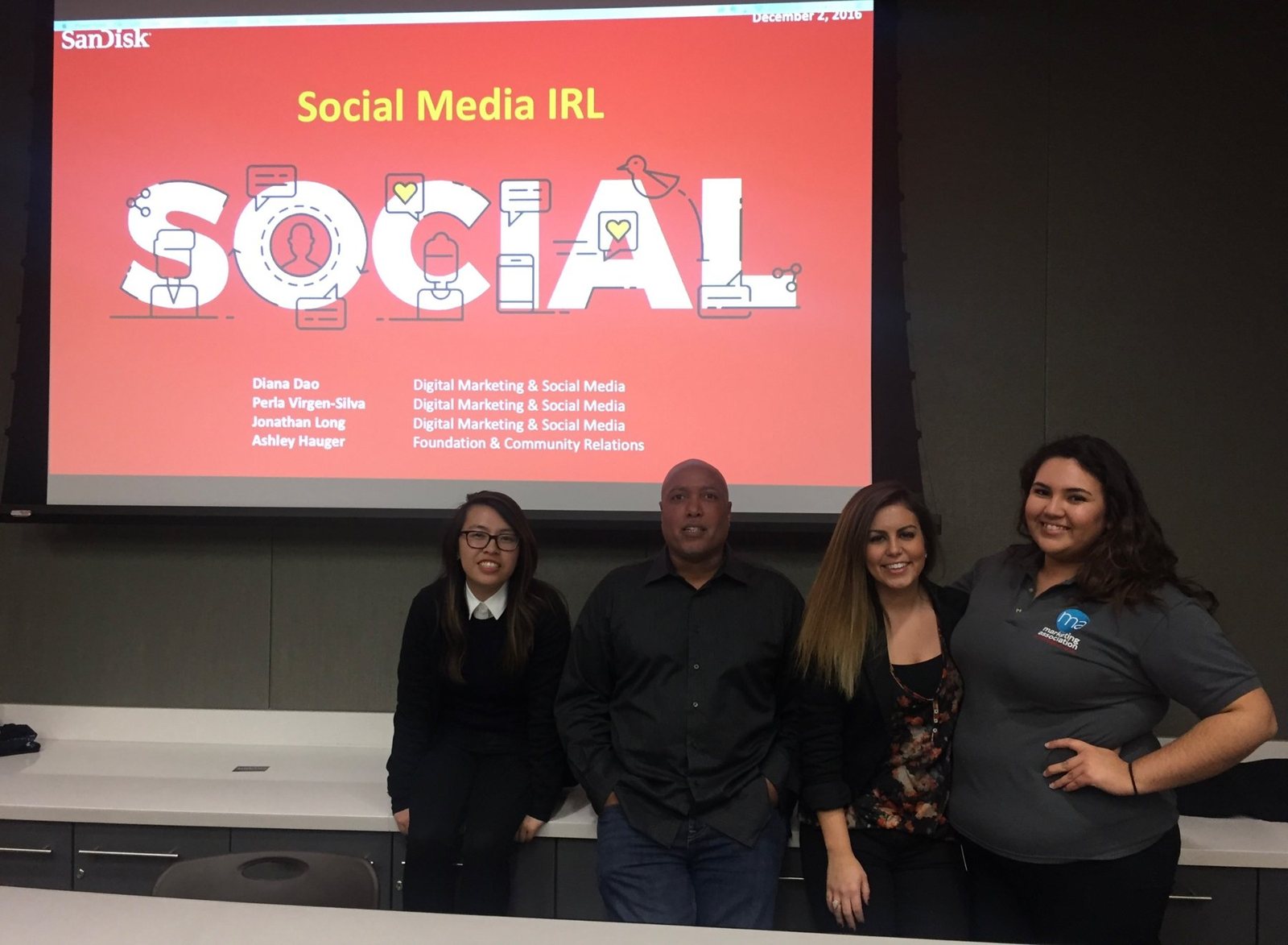 Diana with her SanDisk teammates and a club member in front of a Social Media IRL slide
