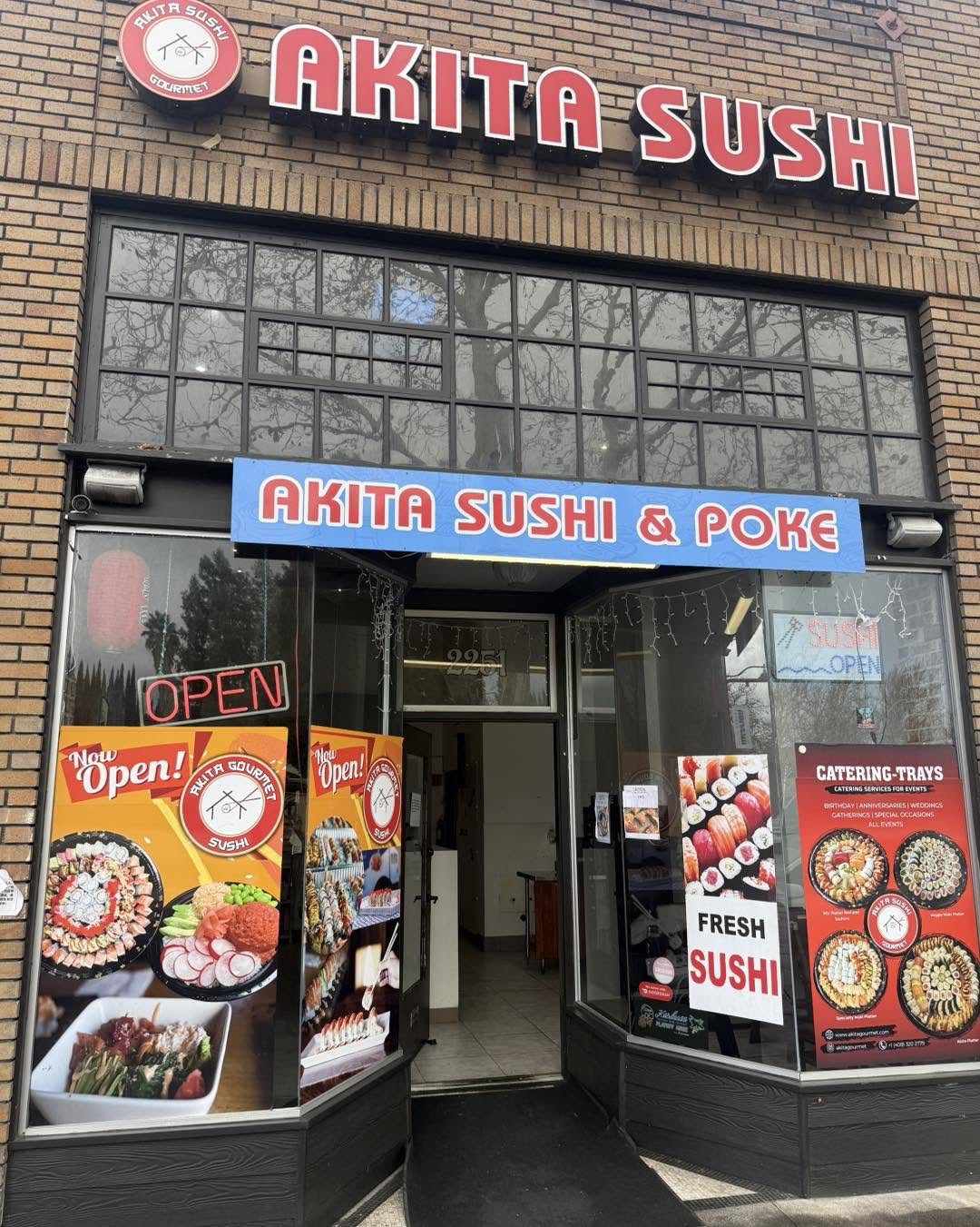 Akita Sushi storefront with the logo on the sign