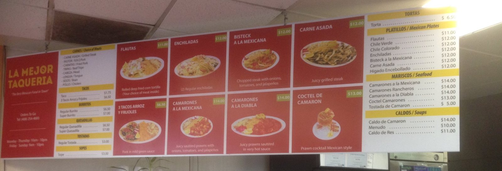 The finished La Mejor Taqueria menu board hanging above the counter